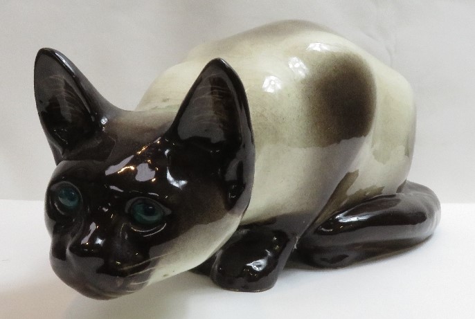 A Winstanley figure of a Siamese cat with green glass eyes, signed to the base and numbered 45, 40cm