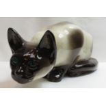 A Winstanley figure of a Siamese cat with green glass eyes, signed to the base and numbered 45, 40cm