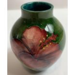 An early 20th century Moorcroft vase in the Hibiscus patten, with paper label to the base, 9cm high