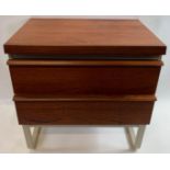 A mid century teak bedside cabinet with two long drawers, the base, back and sides painted, 61cm