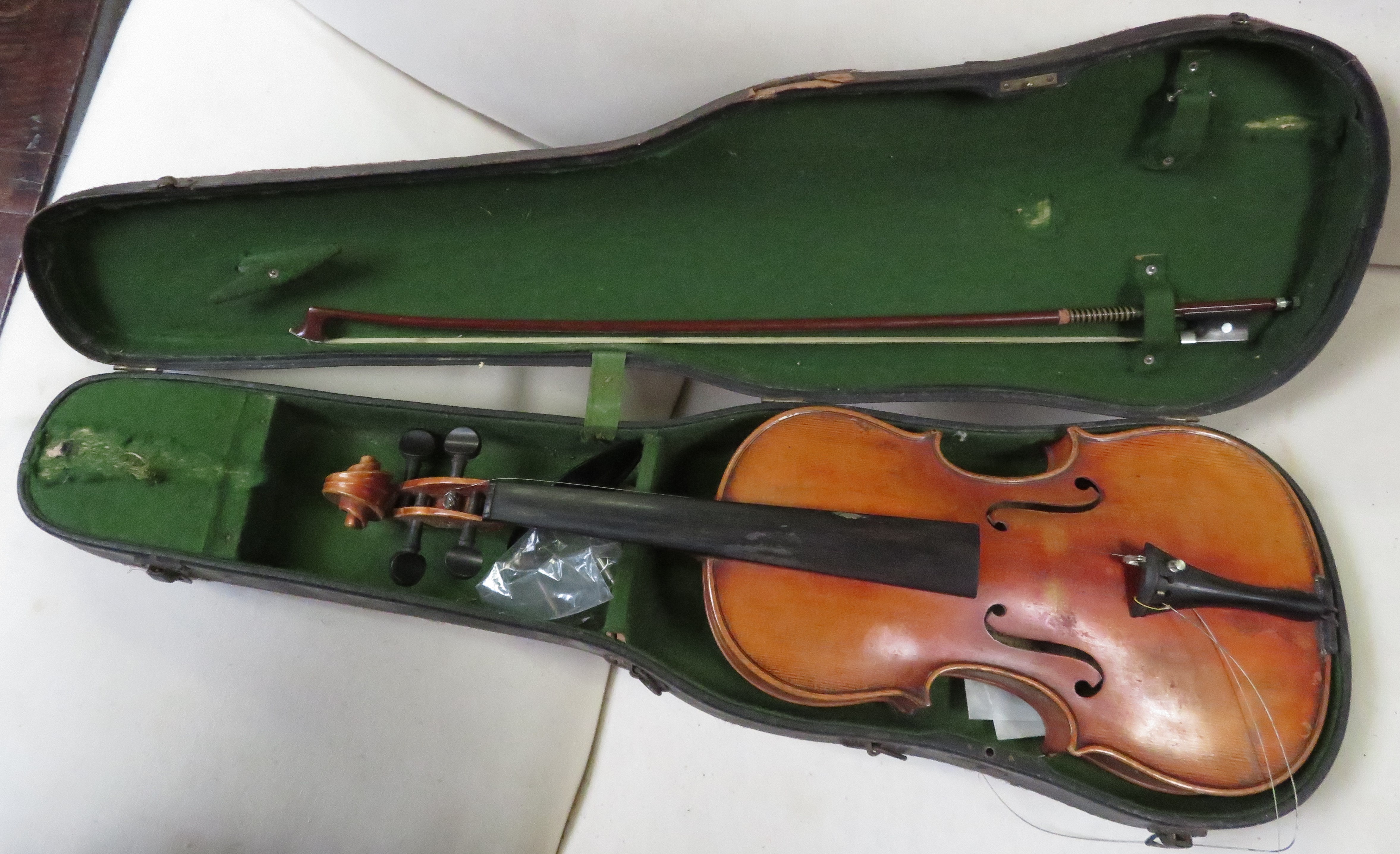 A violin labelled The Metro Violin Class Organisation and bow labelled Bausch copy""