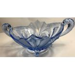 An Art Deco moulded blue glass centre piece, with fish handles standing on four scrolled feet,