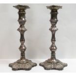 A pair of loaded silver candlesticks, in the George III style, by Richards & Knight, London 1966, 24