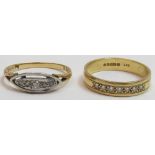 A ring, stamped '18ct' set with five small diamonds; with an 18 carat gold ring set with