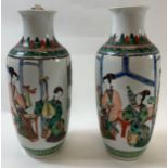 A pair of Chinese vases each decorated with various musicians, 33cm high