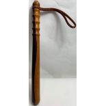 A wooden police truncheon