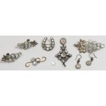 A collection of moonstone set white metal jewellery, comprising: a two brooches; a pair of screw