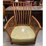An Ercol 'Renaissance' low armchair, with base upholstered in green fabric but lacking cushions,
