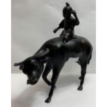 A Chinese bronze model of a water buffalo with a seated child, 21cm long, 20cm high