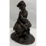 A 20th century bronze figure of a girl seated on a rocky base, 16cm high