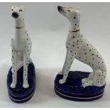 A pair of Staffordshire style figures of Dalmatian dogs, 22cm high