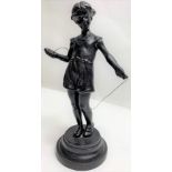 A 20th century Russian figure of standing girl with a skipping rope, probably made from iron, 21cm