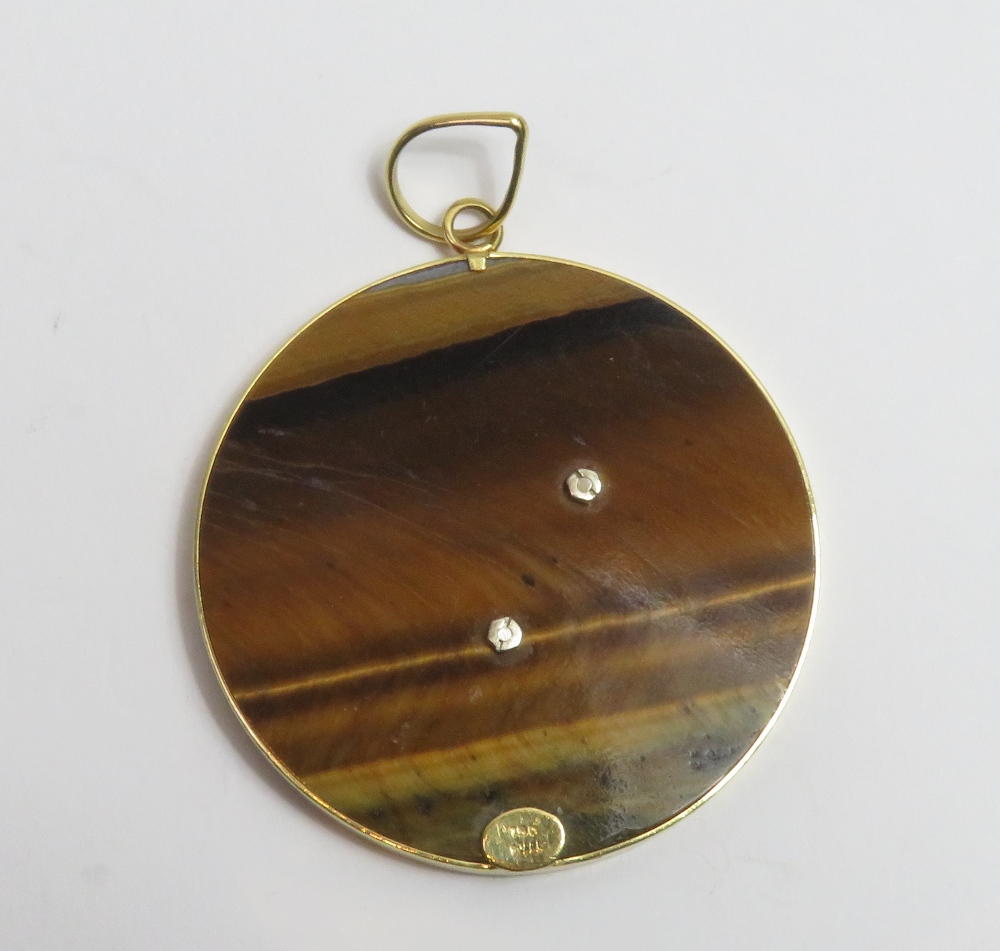 An Aries the Ram tiger eye pendant, the applied symbol for Aries to a frame tagged '750' to the - Image 2 of 4