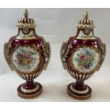 A pair of 19th century porcelain vases and covers, each decorated with flowers, two oval panels