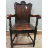 ## WITHDRAWN ## An 18th century oak and elm wainscot armchair with shaped rectangular