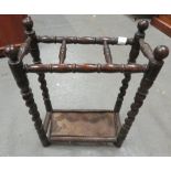 An early 20th century stained oak umbrella/stick stand, with turned and barley twist uprights and