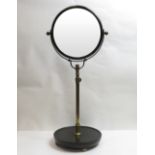 A 19th century adjustable single sided shaving mirror, with brass frame and round ebonised base