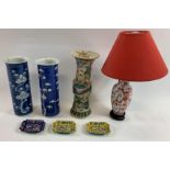 A pair of Chinese vases, each decorated with prunus trees along with single Chinese vase, lamp and