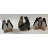 Three Royal Copenhagen figures, to include one of a seal and two of penguins
