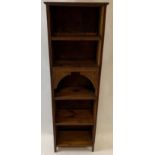 An unusual early 20th century slim oak bookcase, with five fixed shelves and with small pull out