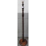A 20th century oak standard lamp with turned and barley twist stem, and round turned base, 150cm