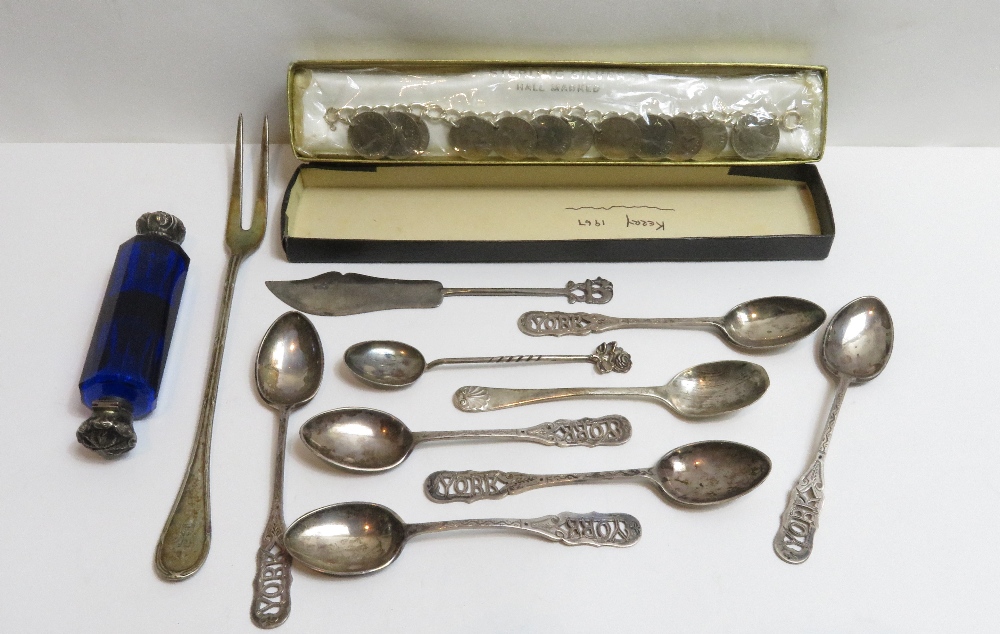 A set of six silver souvenir spoons, pierced with York to the finial; a silver tea spoon; a