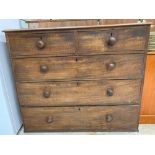 A 20th century stained oak chest of two short and