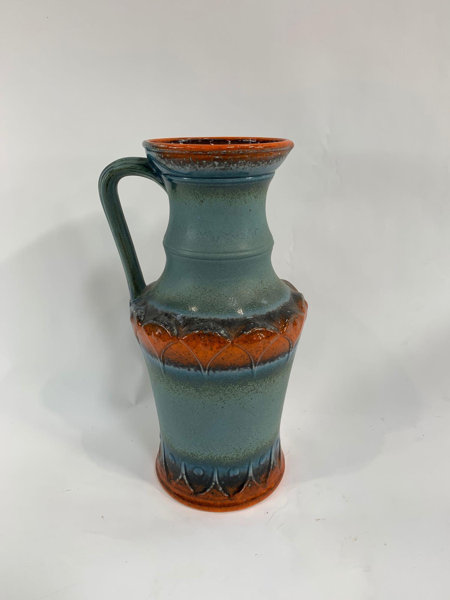 A 20th century German pottery jug, with raised dec