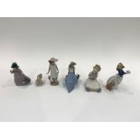 Six Nao figures including seated girl with book, 1