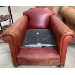 A Victorian low deep armchair, upholstered in red