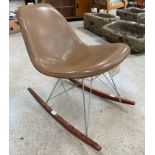 A Herman Miller Eames rocking chair, the tan leath