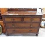 An early 20th century oak chest of two short and t