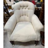 A Victorian upholstered button back chair with tur