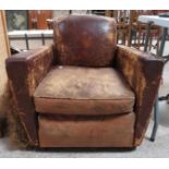 A 20th century brown leather smokers chair on four