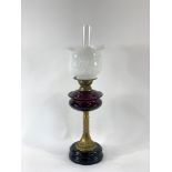 A Victorian oil lamp on black ceramic glazed base,