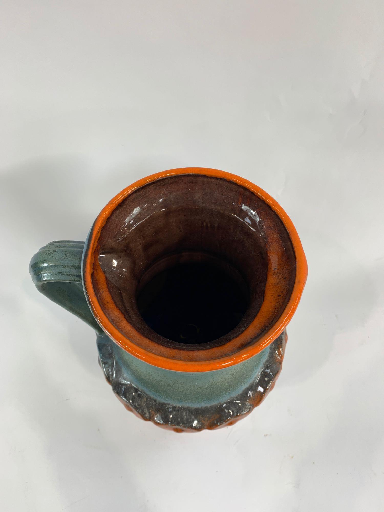 A 20th century German pottery jug, with raised dec - Image 2 of 3