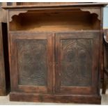 A 20th century stained dark oak cupboard, the top
