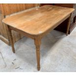 A 20th century pine rectangular kitchen table, the