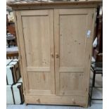 A stripped pine double wardrobe, the two panel doo