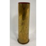 A large WWI brass shell casing, stamped to the bas