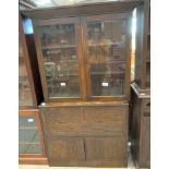 20th century stained oak bookshelf with 2 glazed doors, on associated base