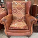 Brown leather & heavy material wingback armchair.