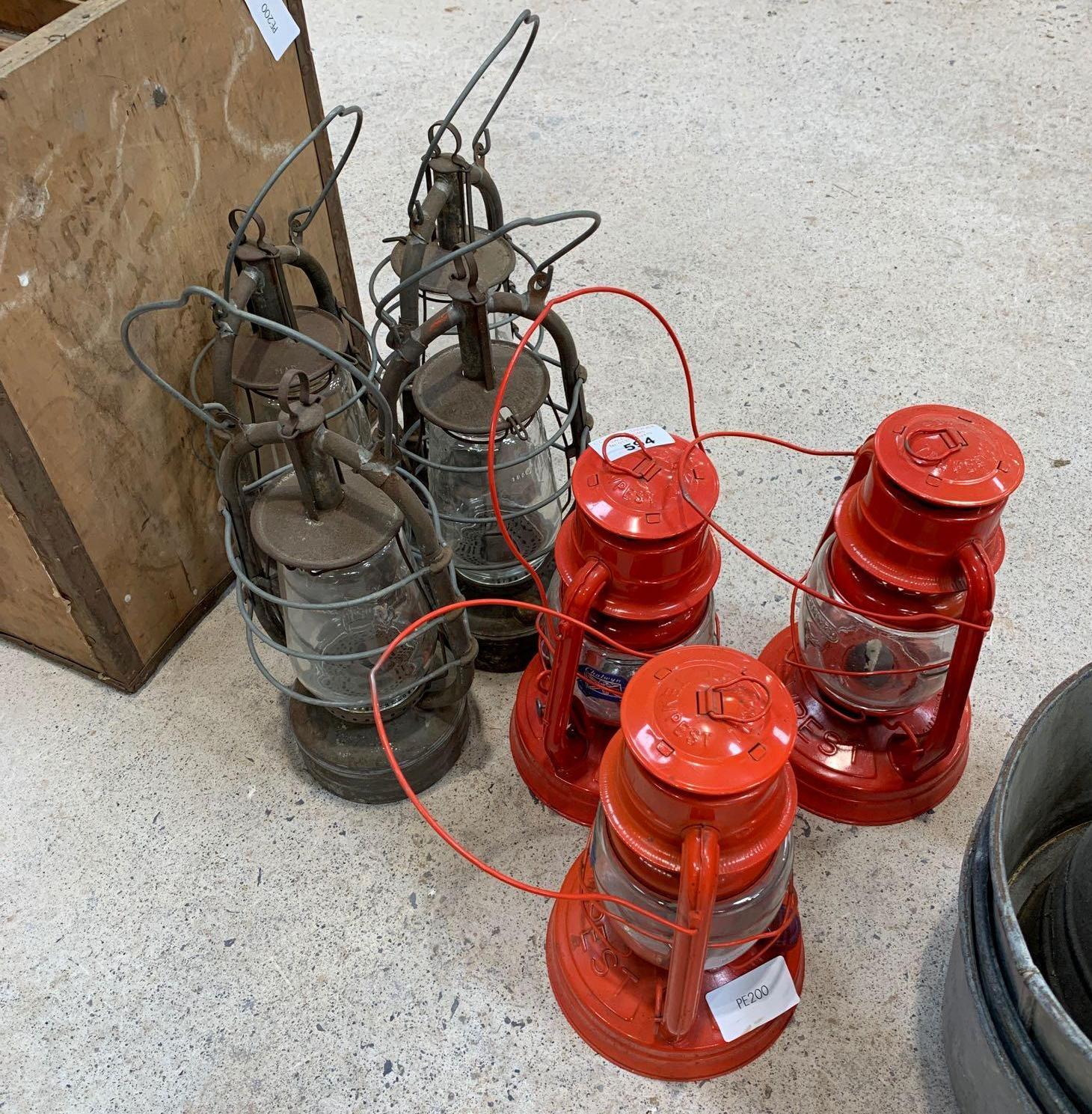 3 red Chalwyn oil lanterns & 4 other oil lanterns.