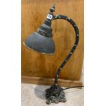 An industrial/vintage style desk lamp on a decorat
