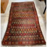 A 20th century wool rug, in bright colours with re