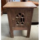 An Arts and Crafts bedside cabinet the door with o