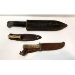 A broad bladed military knife having composition g