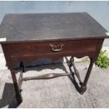 A George III dark oak lowboy fitted with single dr