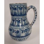 An early Delft blue and white jug painted with pan