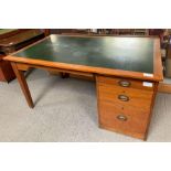 A large early 20th Century desk with inset green w